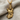 Close-up of handcrafted 925 sterling silver Zeus pendant with gold vermeil finish resting on textured fabric.