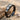 Three stone engagement ring, black rhodium, product photo on sand