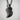 Resting Swan Pendant, black rhodium, hanging on chain against wall