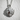 Windswept Sun Face Pendant, polished silver, front view on textured wall