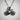 Road bicycle pendant, black rhodium plated, front view on textured wall