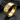 Close-up angled view of 925 sterling silver double Venus ring with gold finish on dark textured stone