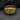 Close-up of the premium all seeing eye ring showing the intricate high-relief iris resting on a dark stone surface.