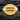 Close-up of the polished equality signet ring resting on a dark stone background displaying its geometric design