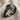 Overlapping Leaf Ring, black rhodium plated, angled view on linen fabric