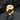 Close-up of gold vermeil equality symbol ring resting on dark textured stone showing engraved details.
