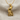 Close-up of the 14k gold vermeil ancient Egyptian Horus pendant displayed elegantly on a soft beige fabric