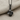 Stemmed Rose Pendant, black rhodium, front view on textured fabric