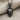 Hockey Goalie Mask Pendant, black rhodium, front view on fabric