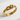 Close-up of the handcrafted love knot ring resting on a textured white surface highlighting its seamless dimensional curves