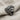 Fierce gorilla ring, oxidized silver, three-quarter angle view on fabric