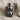 Teddy bear pendant in black rhodium, front view on fabric