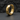 Macro view of geometric hoop earring resting on a textured dark stone background showing crisp metalwork