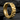 Thick geometric hoop earring displaying intricate zigzag ridge pattern resting on dark textured stone