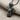 Electric Mouse Pendant, black rhodium plated, angled view on linen