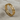 Side angle of the delicate eternity heart ring highlighting the repeating interlocking geometric band design