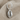 Cowrie Shell Earring in polished silver, product photo on fabric