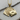 Close-up of the intricately carved 925 sterling silver Royal Flush pendant resting beautifully on a wooden log.