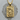 Close-up of the 925 sterling silver Celtic wolf pendant with gold vermeil resting on a textured wooden slice background