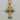 Close-up of the 925 sterling silver base gothic cross pendant with gold finish resting on textured wood grain