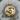 Handcrafted zodiac Pisces pendant resting on a natural wood slice highlighting the intricate fish scale craftsmanship