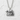Hokkaido Bear Pendant, polished silver, front view on textured wall