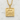 Frontal view of the Japanese Mu pendant resting on a textured white background highlighting its solid construction