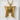 Close-up of the architectural torii gate pendant resting on a white textured stone displaying intricate metalwork