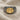 Close-up of ancient-inspired 925 sterling silver signet ring with gold Croeseid coin replica resting on textured fabric