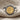 Detailed view of the oxidized silver Arethusa coin ring resting on textured linen fabric highlighting dolphin details
