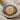 Close-up of 925 sterling silver Alexander coin ring resting on linen showing intricate Herakles lion headdress