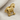Close-up of gold vermeil Trojan horse lapel pin on fabric highlighting intricate oxidized rivet details