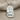 Teshub Storm God Pendant, polished silver finish, front view on fabric