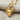 Hittite Bull Pendant, gold vermeil, front view on fabric