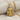 Close-up of ancient Anatolian Kybele goddess pendant resting on textured fabric showing intricate lion details