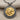 Detailed view of handcrafted ancient Lydian lion pendant showing hammered silver texture and gold raised relief.