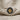 Close-up of handcrafted 925 sterling silver ring with intricate gold vermeil sun motif resting on textured linen.
