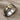 Teshub lightning ring, two-tone finish, angled view on textured fabric