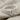 Gordian Knot Ring, polished silver, angled view on fabric