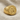 Angled view of handcrafted Hittite royal stamp seal ring resting on a textured linen fabric background.