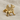 Side profile of mythical griffin stud earring showing ancient Urartian design details resting on textured linen