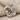 Mother holding baby pendant in polished silver, angled view on fabric