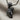 Microphone Fist Pendant, black rhodium plated, angled view on linen fabric
