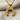 Inverted Horseshoe Pendant, gold vermeil, on chain against fabric background