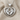 Heart frame baby feet pendant, polished silver, front product view on linen