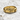 Detailed close up of praying hands ring with intricate sculpted fingers resting on marble stone surface