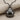 Domed ladybug beetle pendant, black rhodium plated, front view on fabric