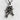 Crossed Pistols Pirate Skull Pendant, oxidized silver, angled view on stone