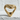 Front angled view of gold snake head ring displaying cobra hood shape resting on textured white surface