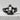 Half Skull Jaw Ring, black rhodium finish, front view on stone surface